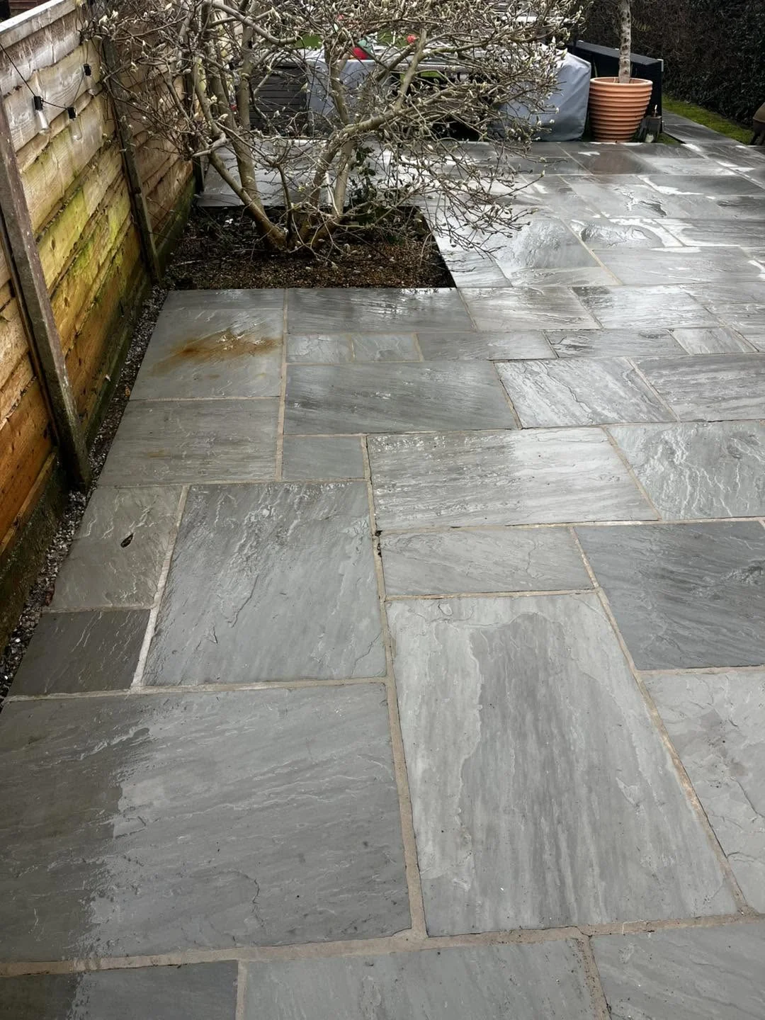 Grey natural stone patio after outdoor surface cleaning